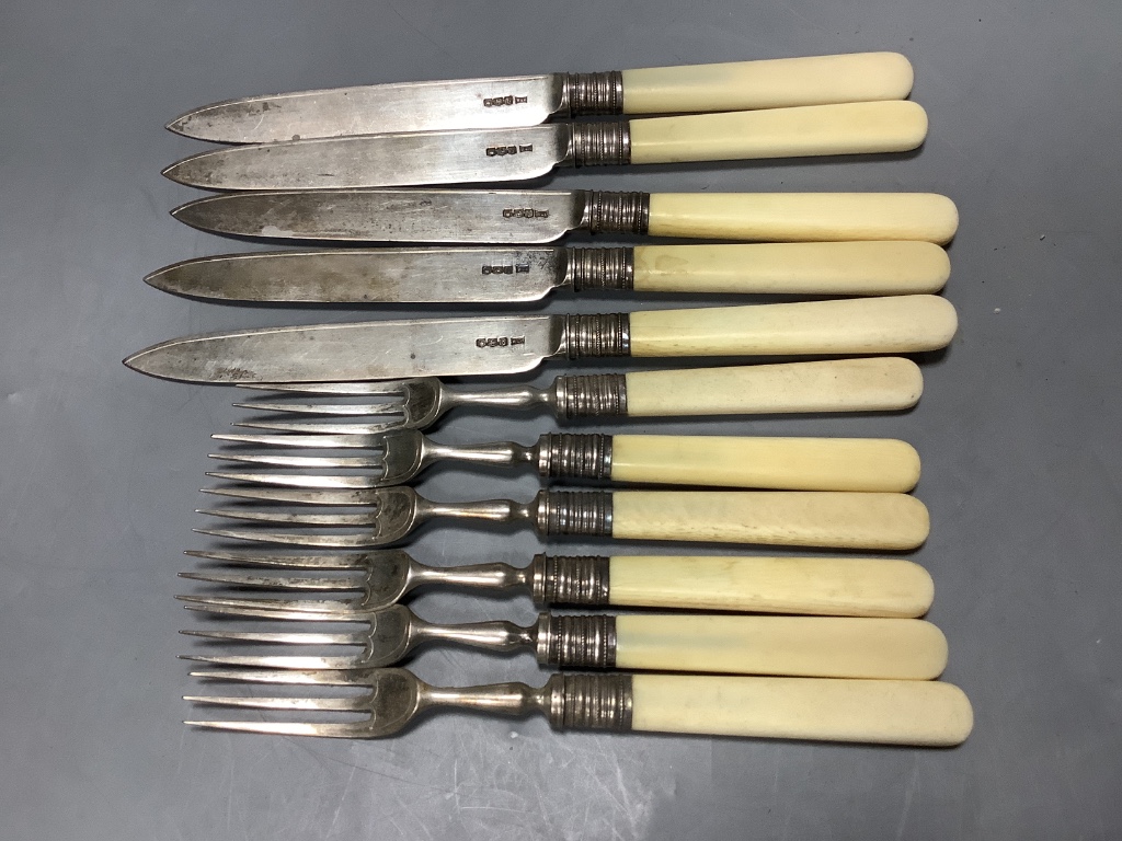 Five pairs of George V ivory handled silver dessert eaters and one other fork, Walker & Hall, Sheffield, 1919.